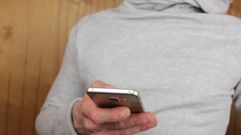 A man with a smartphone close-up. A guy in a light jacket uses a smartphone. Stock Footage 201716995