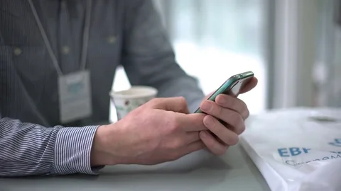 A man with a smartphone. Close-up of the hand at the break. Stock Footage 75447378