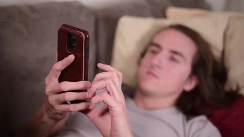 Man with smartphone on couch. Stock Footage 147054092