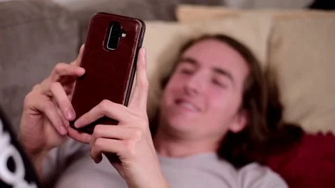 Man with smartphone on couch. Stock Footage 147054105