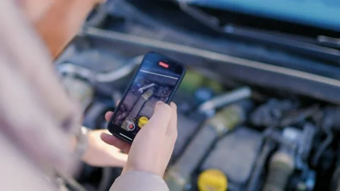 A man with smartphone examines the damage engine Stock Footage 234692773