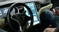 Man with smartphone inside Tesla electromobile at exhibition of electric cars HD Footage