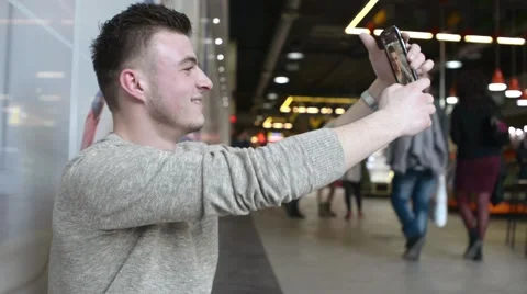 A man with Smartphone mobile cell phone in a hand Makes Selfie Photos Stock Footage 60377635