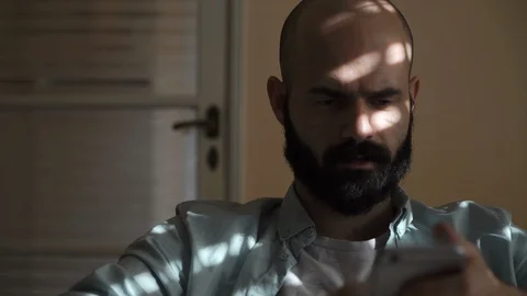 Man with Smartphone Nodding Video stock 85604463