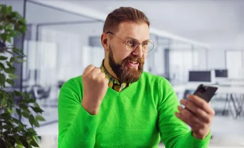 Man with smartphone at office Stock Photos