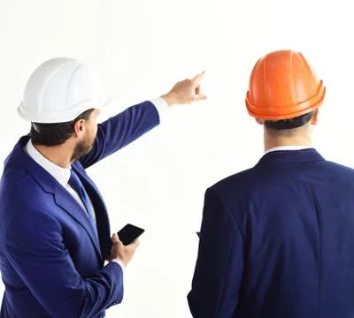 Man with smartphone points something with his finger. 스톡 사진