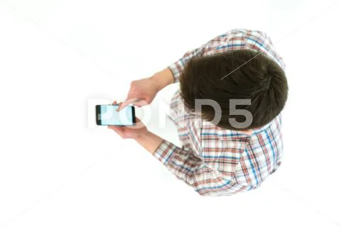 The man with smartphone stand on the white background. View from above Stock Photos