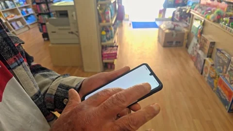 Man with a smartphone in the store Stock Footage 277173734