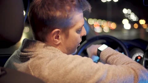 Man with smartwatch in a car using voice recorder recognition audio message Stock Footage 143902197