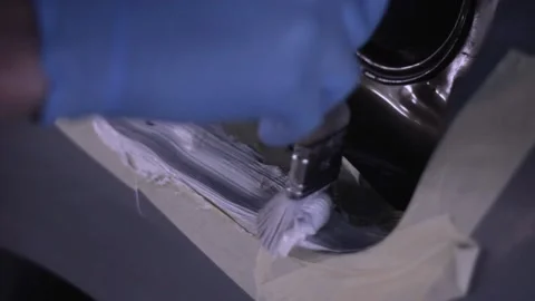 Man smearing hermetization sealing paste on car body during repair service Stock Footage 130576622