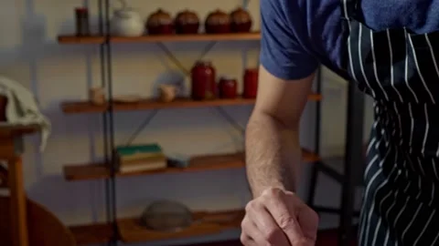 A man smears eclairs with protein cream. Father is preparing a holiday surprise Stock Footage 237431347