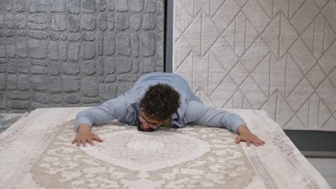 Man smelling and touching new rug in a carpet store Video stock 336965817