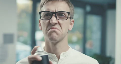 Man smelling a bad odor and spraying air freshener Stock Footage 168367106