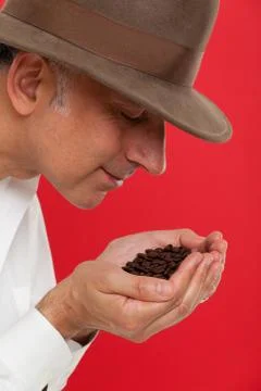 Man smelling coffee beans Stock Photos