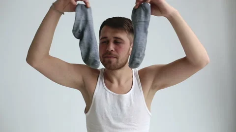 Man is smelling his socks Видео 44391130