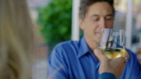 Man smiles and cheers his wife in a restaurant 59743414