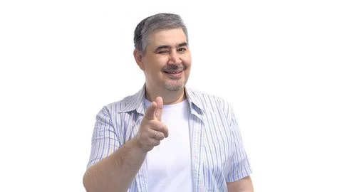 A man smiles and points at the camera. Isolated on white. 库存照片