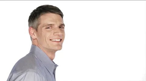 Man smiles into the camera then turns his head on a white background Stock Footage 33842095