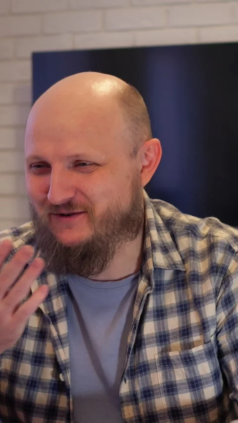 Man smiles during creative group discussion. Individual laughing while Stock-Footage 344718176