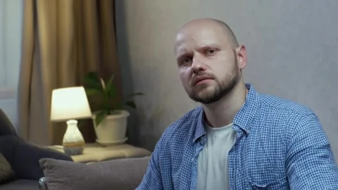 A man smiles. His smile is replaced by surprise and a negative shake of his head Stock-Footage 242599415