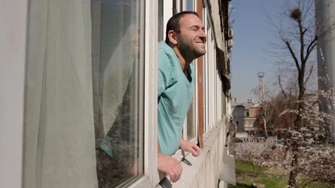 Man smiles near the window Stock Footage 128438833