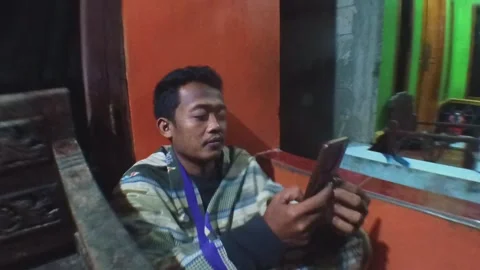 A man smiles while using his smartphone in a outdoor Stock Footage 317937045