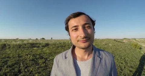 Man smiling and drinking coffee on blue sky background Stock Footage 76473167