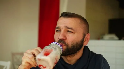 Man smiling and drinking sheik Stock Footage 67992856