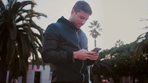 Man smiling and laughing of message he received he is hired for a job or texting Stock Footage 101489523