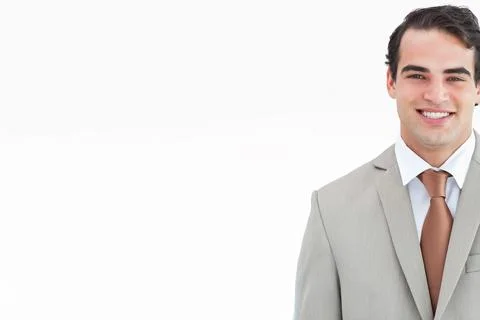 Man smiling and posing in studio wearing light gray suit white shirt brown tie, Stock Photos
