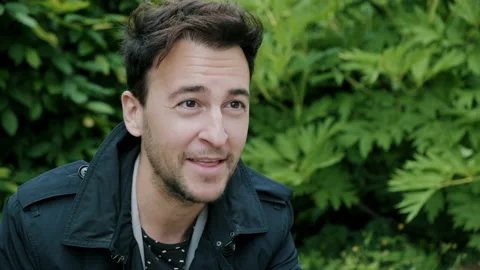 Man smiling and talking and looking up Video stock 130596355