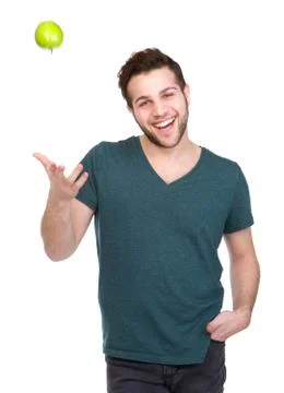 Man smiling and throwing apple up Foto stock
