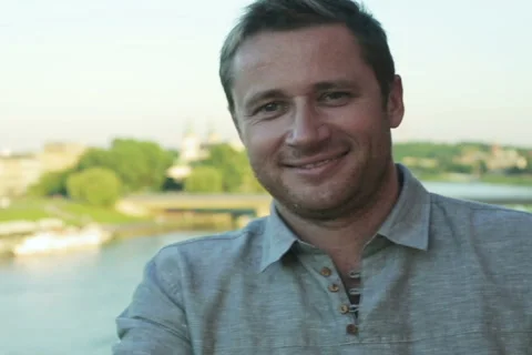Man smiling to the camera in the terrace next to the river Stock-Footage 40612363