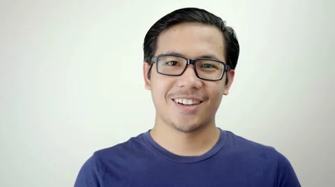 Man Smiling Close up Portrait on White Background in Studio Slow Motion Stock Footage 59949424