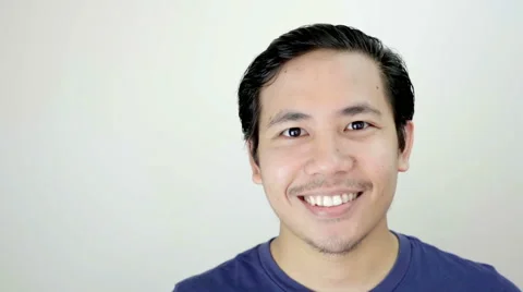 Man Smiling Close up Portrait on White Background in Studio Slow Motion Video stock 59949636