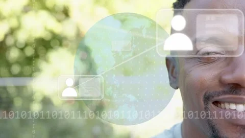 Man smiling as digital globe emerging, animating icons and binary by cheek, Stock Footage 333602228