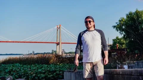 Man smiling in front of a bridge Stock Photos