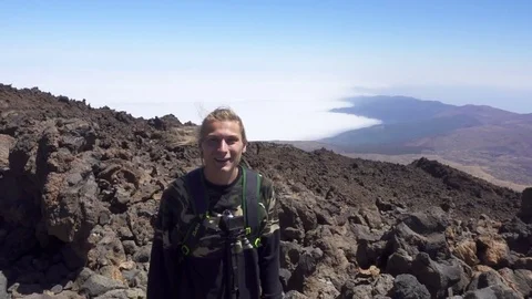 Man Smiling In Front Of The Camera Standing At The Mountain Top Stock Footage 72037772