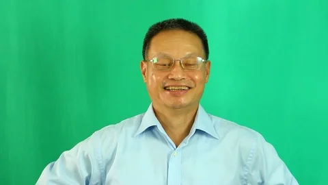 Man smiling with green background,  in studio Chiangmai Thailand Stock Footage 113310294