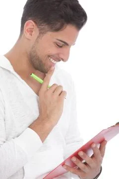 Man smiling as he reads notes on a clipboard Stock Photos