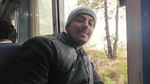 Man smiling inside vintage kalka shimla toy train himachal pradesh india Stock Footage 333982596