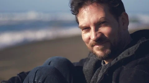 Man smiling looking camera in front of the ocean after the end of quarantine  Stock Footage 129519597