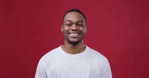 Man smiling over maroon background Video stock 147620310