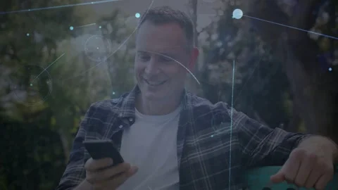 Man smiling on smartphone then ending call and reading messages while tech Stock Footage 333169194