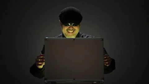 Man smiling suspiciously as he opens a glowing briefcase in the dark Stock Footage 336765873