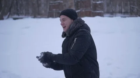 Man smiling throwing snow directly into the camera 库存影片 72250845