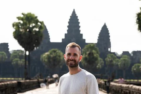 Man smiling visiting angkor wat temple in cambodia Stock Photos