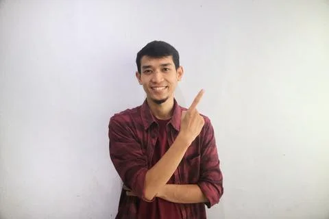 A man smiling when looking and pointing to his left side Stock Photos