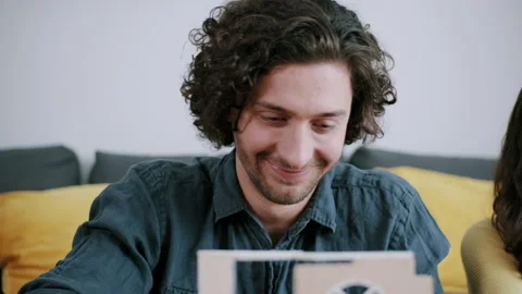 Man smiling while building miniature house Stock Footage 130322094