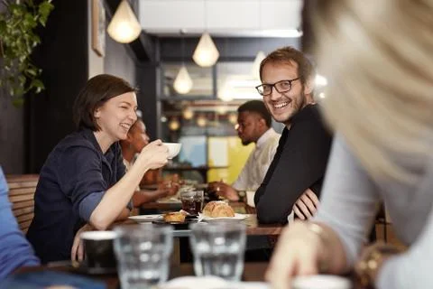 Man smiling while on a coffee date with his girlfriend Stock Photos